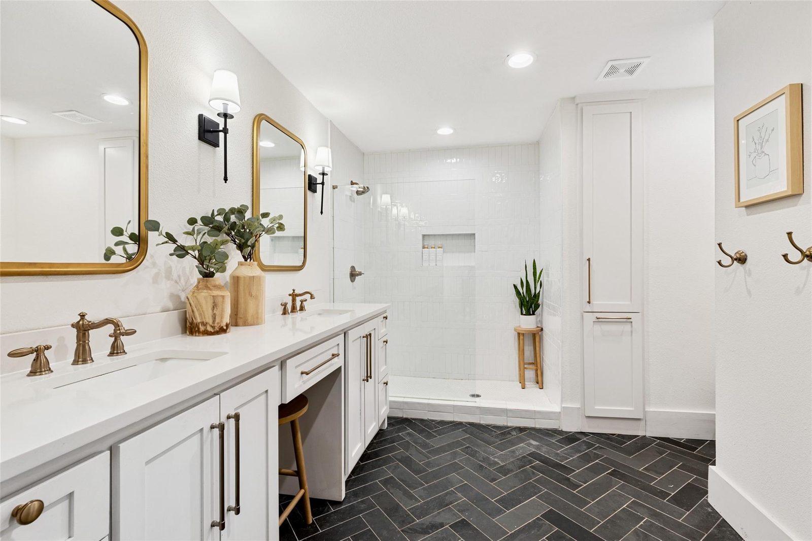 After: herringbone slate floor, white vanity, walk-in shower, brass fixtures
