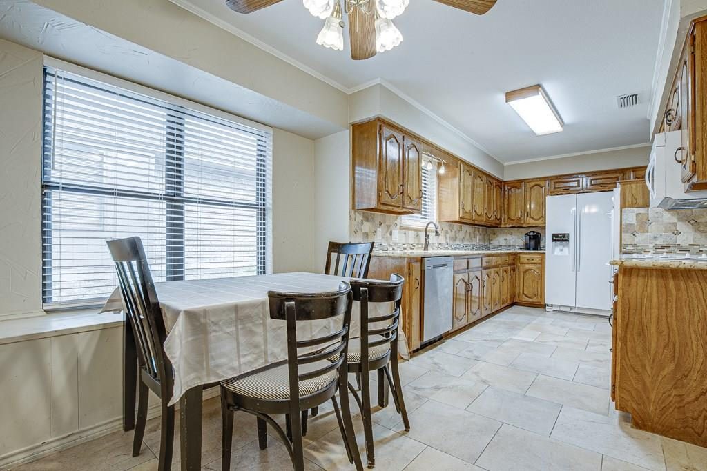 Before: oak cabinets, tile floor, small window over the sink