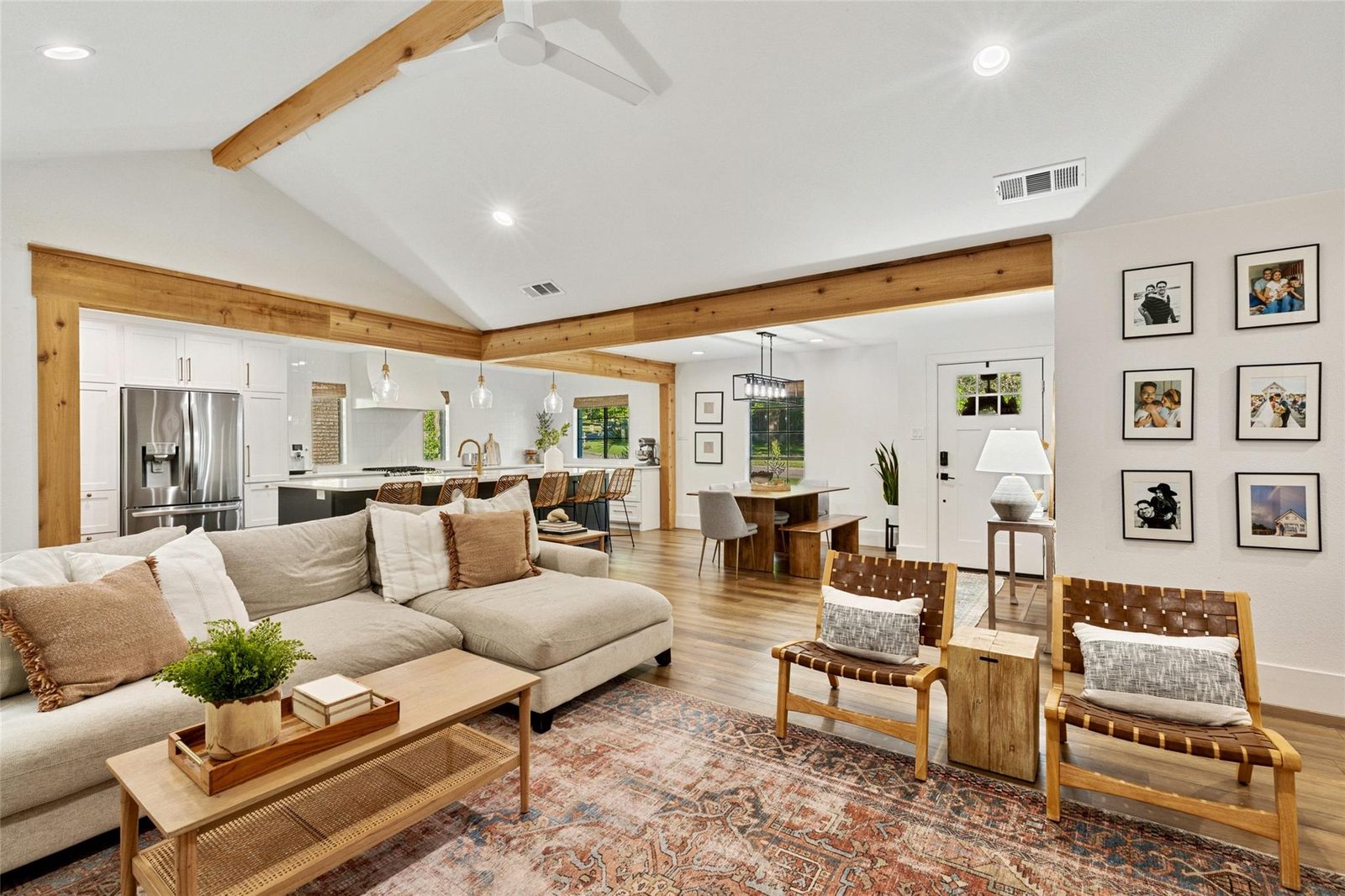 After: opened to the kitchen, cedar beams, wood floors, layered rug